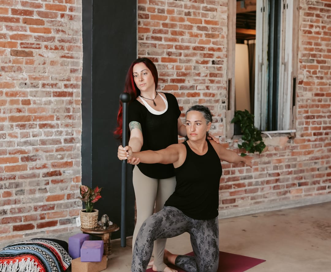 Krysta guiding a client through a slow standing movement during an embodiment coaching session